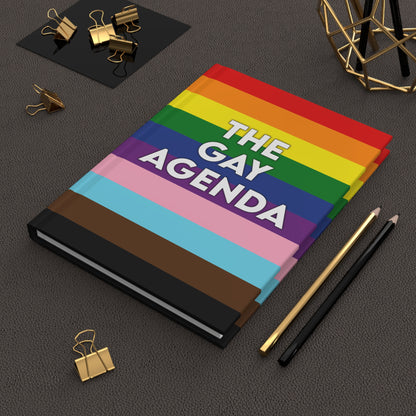 Front cover of The Gay Agenda LGBTQ+ hardcover journal with rainbow design